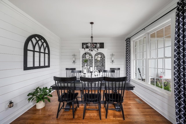 1205 Bradford Crossing Pl, Goode, VA 24556 - dining room featuring wooden walls, visible vents, wood finished floors, and a chandelier