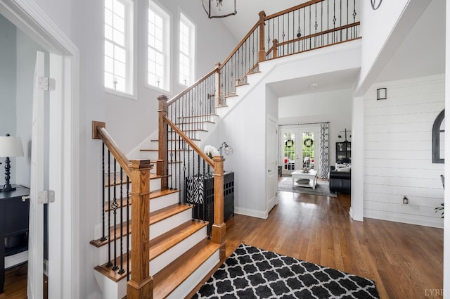 1205 Bradford Crossing Pl, Goode, VA 24556 - stairway with baseboards, a towering ceiling, wood finished floors, and french doors
