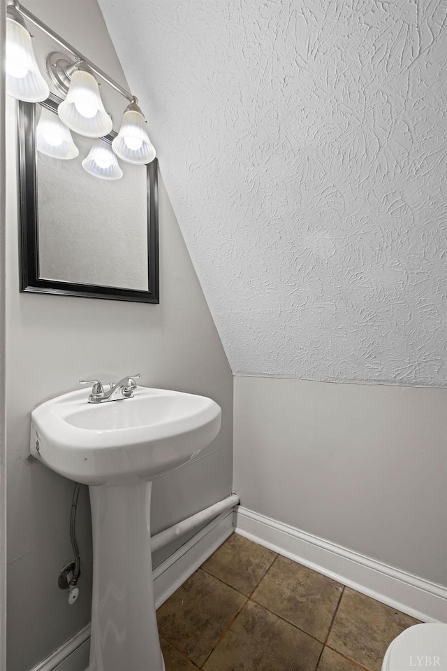 609 Jackson St, Lynchburg, VA 24504 - bathroom with baseboards, tile patterned flooring, a textured ceiling, toilet, and vaulted ceiling