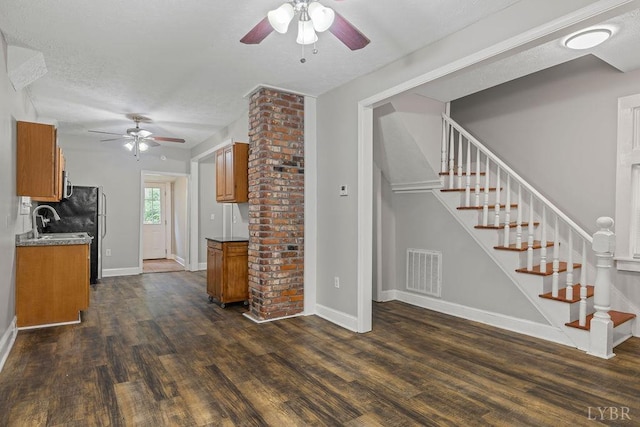 609 Jackson St, Lynchburg, VA 24504 - kitchen featuring brown cabinets, a ceiling fan, dark wood-type flooring, and baseboards