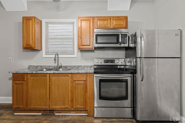 609 Jackson St, Lynchburg, VA 24504 - kitchen featuring stainless steel appliances, a sink, brown cabinetry, and dark wood-type flooring