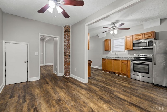 609 Jackson St, Lynchburg, VA 24504 - kitchen featuring appliances with stainless steel finishes, ceiling fan, dark wood-type flooring, a sink, and brown cabinets