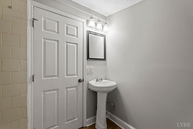 609 Jackson St, Lynchburg, VA 24504 - bathroom featuring baseboards and a sink