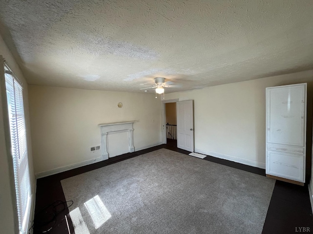 1603 Taylor St, Lynchburg, VA 24504 - unfurnished bedroom featuring a textured ceiling, baseboards, a ceiling fan, and dark carpet