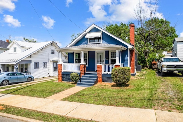 730 Stuart St, Lynchburg, VA 24501 - bungalow with a porch, a front lawn, a chimney, and central air condition unit