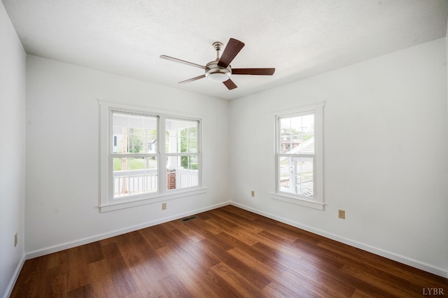 730 Stuart St, Lynchburg, VA 24501 - empty room with plenty of natural light, dark wood-style flooring, baseboards, and a ceiling fan