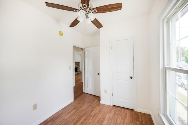 730 Stuart St, Lynchburg, VA 24501 - unfurnished bedroom with light wood-type flooring, baseboards, and a ceiling fan