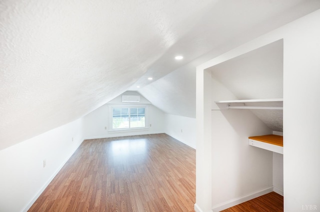 730 Stuart St, Lynchburg, VA 24501 - additional living space featuring a wall unit AC, wood finished floors, baseboards, lofted ceiling, and recessed lighting