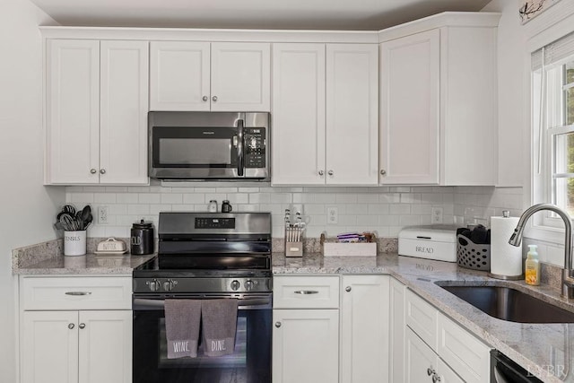 208 Samson Way, Madison Heights, VA 24572 - kitchen featuring stainless steel microwave, electric stove, a sink, and decorative backsplash