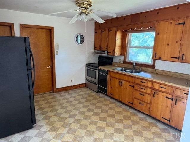 kitchen featuring a sink, light floors, black appliances, and brown cabinets