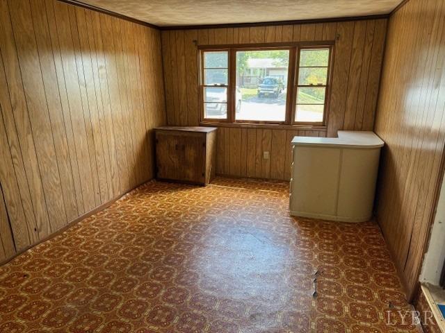 empty room featuring wooden walls