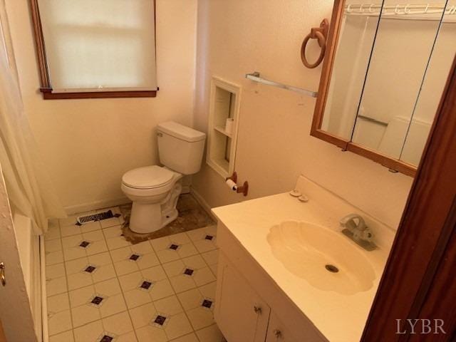 bathroom with toilet, tile patterned flooring, and vanity