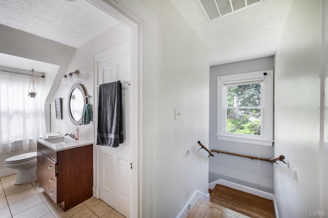 4205 Tremont, Lynchburg, VA 24502 - bathroom with a textured ceiling, toilet, vanity, tile patterned floors, and baseboards