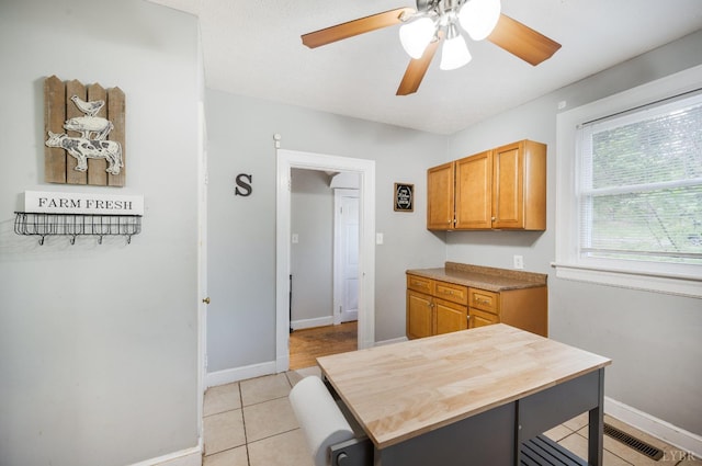 4205 Tremont, Lynchburg, VA 24502 - kitchen with baseboards, a ceiling fan, light tile patterned floors, and brown cabinets