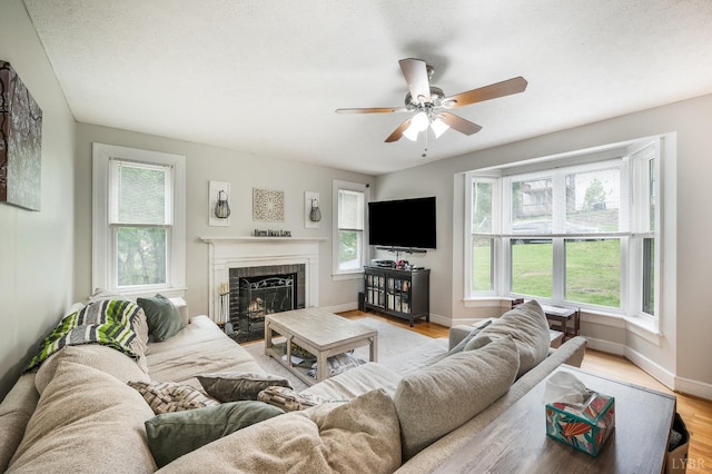 4205 Tremont, Lynchburg, VA 24502 - living room featuring ceiling fan, a brick fireplace, baseboards, and light wood finished floors