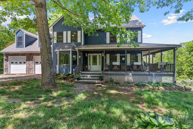 95 Rhage Ln, Lynchburg, VA 24504 - view of front of house with covered porch, metal roof, a garage, stone siding, and driveway