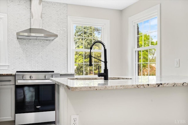 3882 Peakland Pl, Lynchburg, VA 24503 - kitchen featuring stainless steel range with electric cooktop, wall chimney range hood, decorative backsplash, and light stone countertops