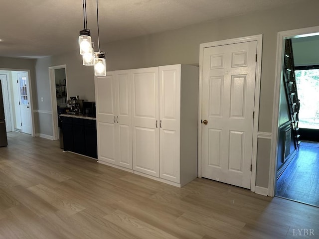 69 Gough Rd, Rustburg, VA 24588 - kitchen with light wood-style flooring, decorative light fixtures, baseboards, and light countertops