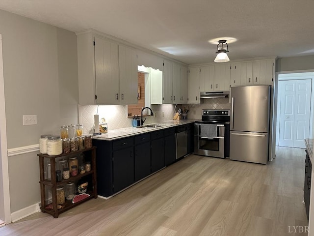 69 Gough Rd, Rustburg, VA 24588 - kitchen featuring appliances with stainless steel finishes, a sink, light wood-style floors, and tasteful backsplash