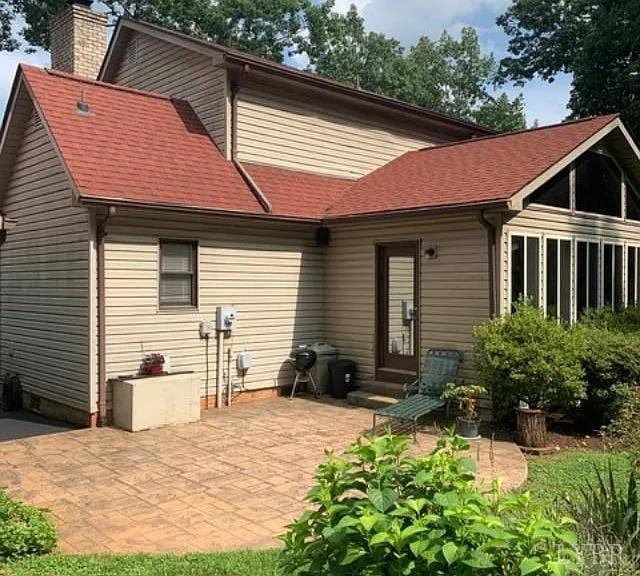 69 Gough Rd, Rustburg, VA 24588 - rear view of house featuring a chimney and a patio area