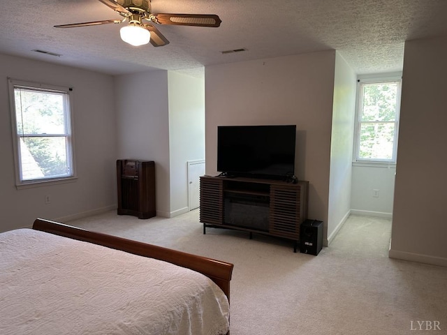 69 Gough Rd, Rustburg, VA 24588 - carpeted bedroom featuring a textured ceiling, multiple windows, baseboards, and a ceiling fan