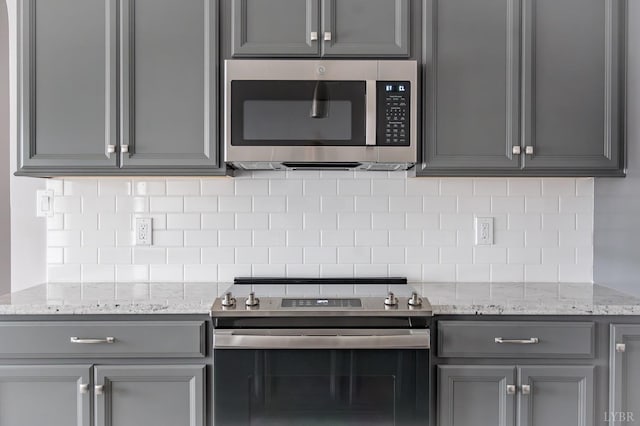 1051 Wills Way, Forest, VA 24551 - kitchen with appliances with stainless steel finishes, gray cabinets, tasteful backsplash, and light stone counters