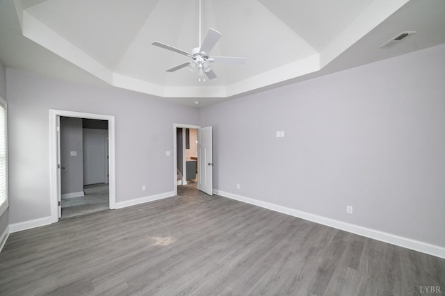 1051 Wills Way, Forest, VA 24551 - unfurnished bedroom featuring a tray ceiling, wood finished floors, baseboards, and ceiling fan