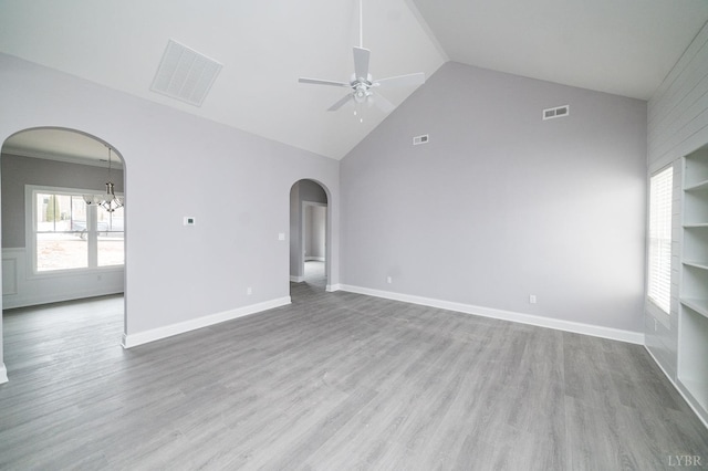 1051 Wills Way, Forest, VA 24551 - empty room featuring arched walkways, ceiling fan, wood finished floors, a chandelier, and high vaulted ceiling
