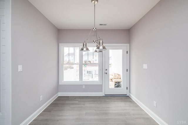 1051 Wills Way, Forest, VA 24551 - unfurnished dining area with a chandelier, wood finished floors, and baseboards
