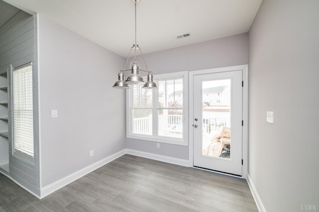 1051 Wills Way, Forest, VA 24551 - unfurnished dining area featuring wood finished floors, baseboards, and a chandelier