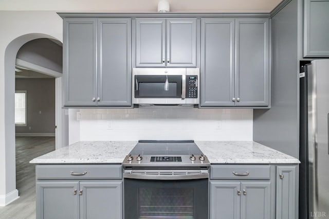 1051 Wills Way, Forest, VA 24551 - kitchen with appliances with stainless steel finishes, gray cabinetry, arched walkways, and light wood finished floors