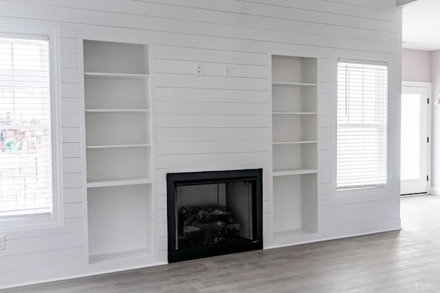 1051 Wills Way, Forest, VA 24551 - unfurnished living room featuring built in shelves, wood finished floors, a fireplace, and wood walls