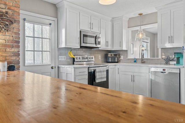 206 Simsbury Ln, Forest, VA 24551 - kitchen featuring appliances with stainless steel finishes, a sink, light countertops, decorative backsplash, and white cabinetry