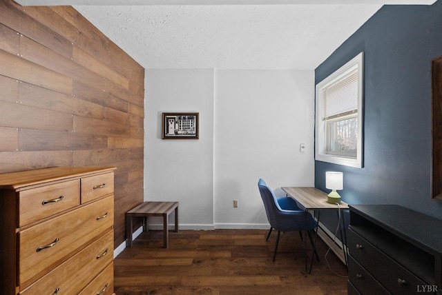 206 Simsbury Ln, Forest, VA 24551 - home office with dark wood-style flooring, a baseboard heating unit, baseboards, wood walls, and a textured ceiling