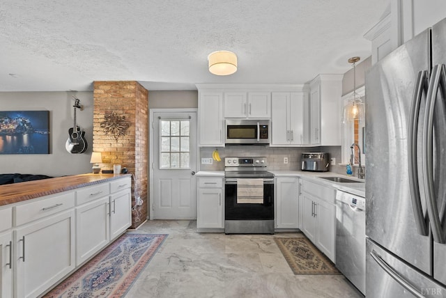 206 Simsbury Ln, Forest, VA 24551 - kitchen with stainless steel appliances, a sink, white cabinets, a textured ceiling, and light countertops