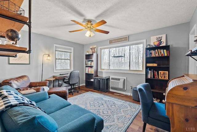 206 Simsbury Ln, Forest, VA 24551 - office area featuring a ceiling fan, wood finished floors, an AC wall unit, baseboards, and a textured ceiling