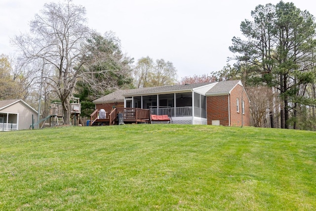2637 Chilton Rd, Appomattox, VA 24522 - rear view of house featuring a sunroom, brick siding, a lawn, and a deck