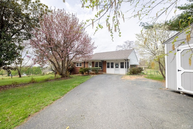 2637 Chilton Rd, Appomattox, VA 24522 - ranch-style house with a front lawn, a storage shed, brick siding, an outdoor structure, and driveway