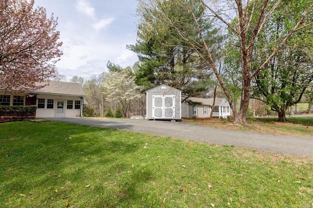 2637 Chilton Rd, Appomattox, VA 24522 - view of grassy yard featuring a shed, an outdoor structure, and asphalt driveway