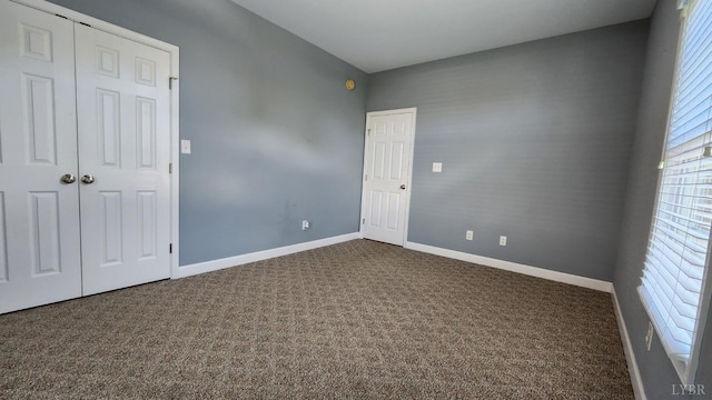 1057 Barrow Hills Dr, Moneta, VA 24104 - unfurnished bedroom with dark carpet, baseboards, and a closet