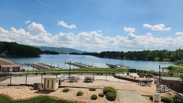 1057 Barrow Hills Dr, Moneta, VA 24104 - water view with a dock, a mountain backdrop, and a forest