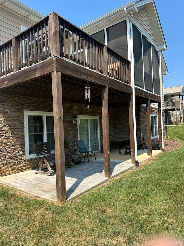 1057 Barrow Hills Dr, Moneta, VA 24104 - rear view of property with a patio area, a lawn, a wooden deck, and a sunroom