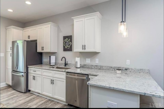 3008 Hill St Unit 313, Lynchburg, VA 24501 - kitchen featuring appliances with stainless steel finishes, white cabinets, recessed lighting, a sink, and light wood finished floors