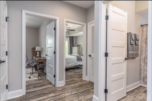 3008 Hill St Unit 313, Lynchburg, VA 24501 - hallway featuring wood finished floors, a desk, and baseboards