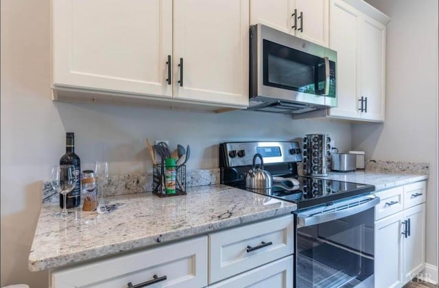 3008 Hill St Unit 313, Lynchburg, VA 24501 - kitchen featuring stainless steel appliances, white cabinets, and light stone counters