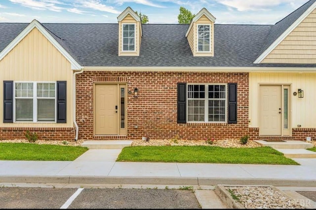 3008 Hill St Unit 313, Lynchburg, VA 24501 - view of front facade with brick siding, a shingled roof, board and batten siding, and a front lawn