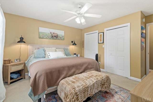 2098 Sunburst Rd, Evington, VA 24550 - carpeted bedroom featuring two closets, baseboards, and ceiling fan