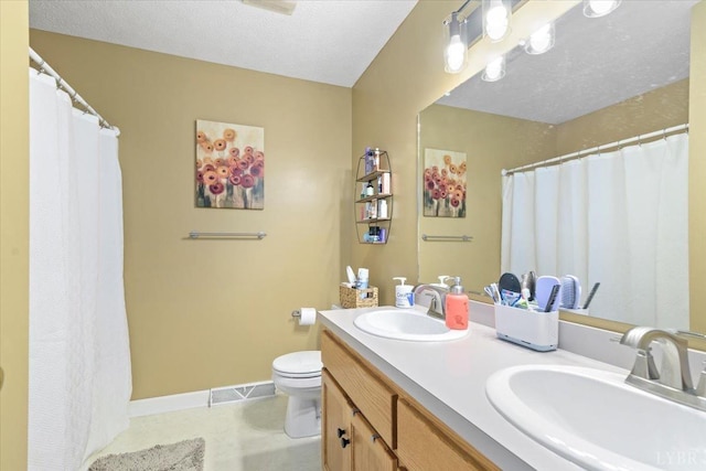 2098 Sunburst Rd, Evington, VA 24550 - full bathroom with toilet, double vanity, baseboards, and tile patterned flooring