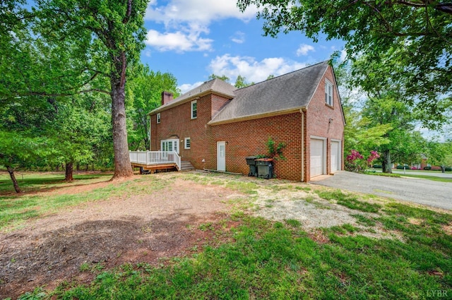 302 Spring Lake Rd, Forest, VA 24551 - view of side of home featuring aphalt driveway, a garage, brick siding, a wooden deck, and a chimney