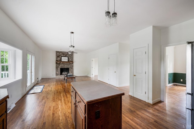 302 Spring Lake Rd, Forest, VA 24551 - kitchen featuring pendant lighting, a fireplace, and wood finished floors